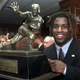 Ricky Williams, winner of the 1998 Heisman Trophy, poses with U.S. college football’s highest honor at the Downtown Athletic Club in New York City.
ADAM NADEL/AFP/Getty Images